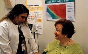 A woman getting her blood pressure checked
