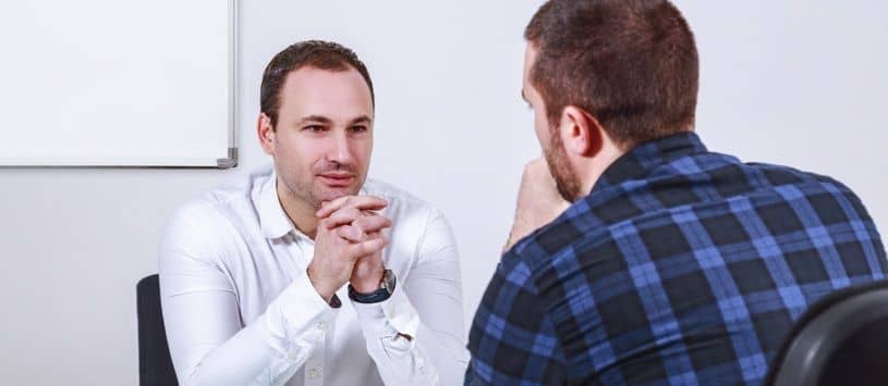 Graduate sitting attentively in job interview.